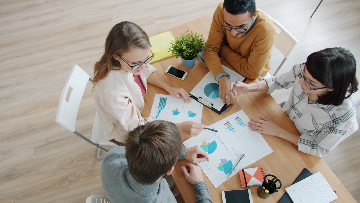 Consulting team collaborating with entrepreneurs around a strategy table